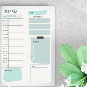 May include: A daily planner with a light blue and green design. The planner has sections for "What I have to do today", "Top Priorities", "My To Do List", "Notes", and "Brain Dump".