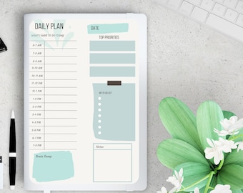 May include: A daily planner with a light blue and green design. The planner has sections for "What I have to do today", "Top Priorities", "My To Do List", "Notes", and "Brain Dump".