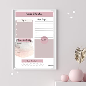 May include: A printable planner with a pink and gray watercolor background. The planner includes sections for "Top 3", "Don't Forget", "Meals for the Day", "Brain Dump", and "Drink Your Water".