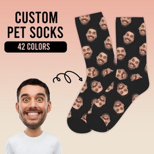 May include: A pair of black socks with a repeating pattern of a person's face. The socks are custom made and have the text "CUSTOM PET SOCKS" and "42 COLORS" printed on the image.