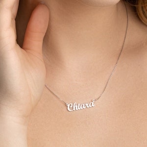 May include: A silver necklace with the name "Chiara" written in cursive script.
