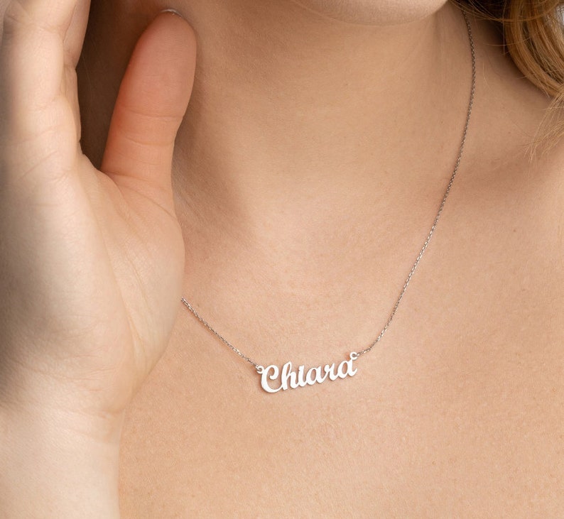 May include: A silver necklace with the name "Chiara" written in cursive script.