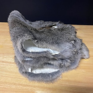 May include: A stack of gray rabbit fur pelts.