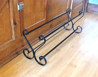 Wrought iron shoe rack. Open topped heart-shape. Handmade and crafted in the UK