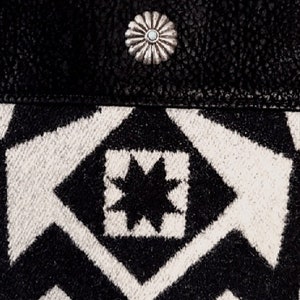 May include: Black and white geometric patterned fabric with a silver starburst button.
