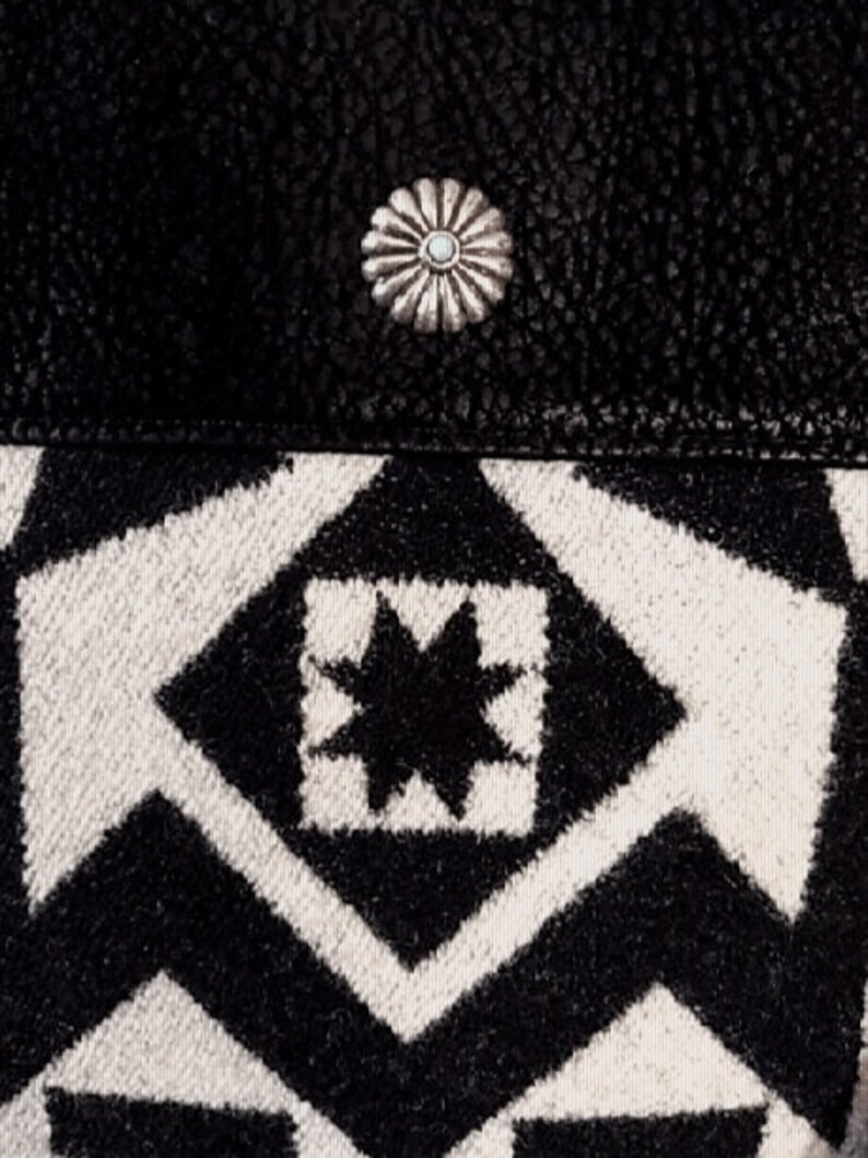 May include: Black and white geometric patterned fabric with a silver starburst button.