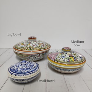 May include: Three ceramic bowls with lids, decorated with colorful floral patterns. The largest bowl is labeled "Big bowl", the middle bowl is labeled "Medium bowl", and the smallest bowl is labeled "Small bowl".
