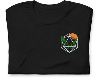 Puede incluir: Camiseta negra con un diseño geométrico blanco con una hoja verde y una flor naranja.