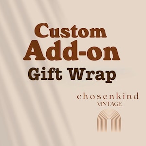 May include: A beige graphic with the words "Custom Add-on Gift Wrap" in brown, stylized font. Below, the text "chosenkind VINTAGE" appears, with an arched design below. The background has a soft, neutral tone.