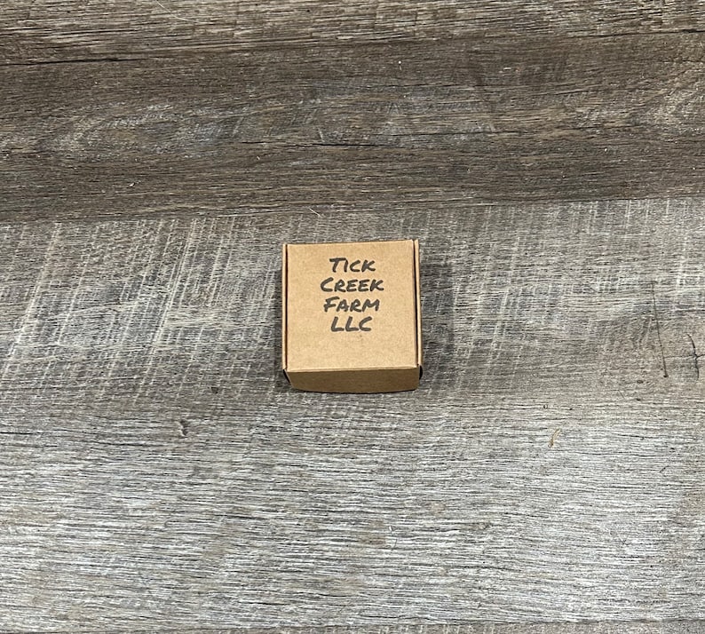 Packaging box folded and closed with Tick Creek Farm LLC printed on the top.