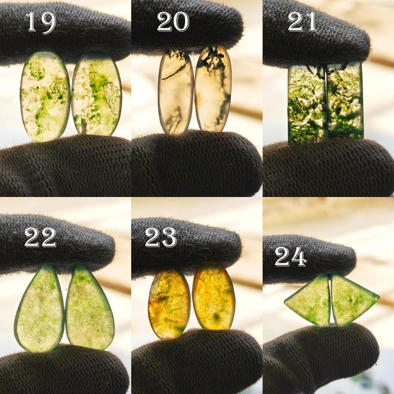 May include: A collection of gemstone cabochons in various shapes, including oval, teardrop, and triangular. The stones display a range of colors, from clear to yellow and green, with unique internal patterns. Each stone is held by a gloved hand.