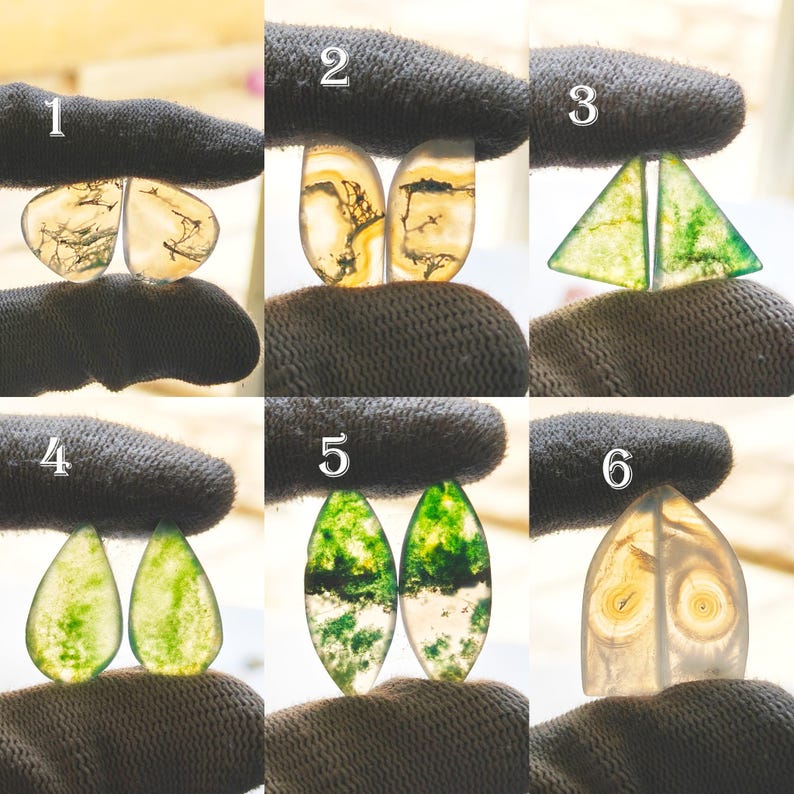 May include: A collection of six pairs of polished gemstones, each held by a gloved hand. The stones vary in shape and color, including translucent white, yellow, and green, with intricate internal patterns resembling landscapes or natural formations.