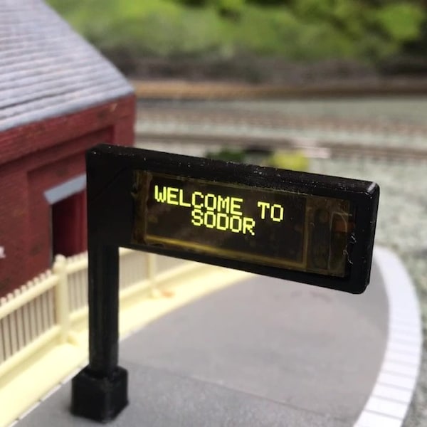 Une gare ferroviaire miniature affiche les quais de l'affichage OLED des horaires des trains et des messages personnels OO HO