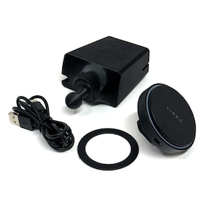 May include: A black car phone mount kit with a USB cable, a circular magnetic pad with the text "LISEN", a mounting base, and a black ring. The kit is designed to hold a phone securely in a vehicle.