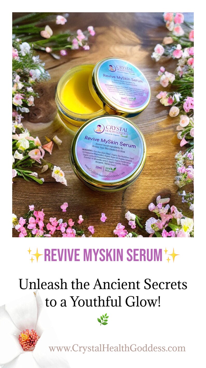 May include: A small jar of yellow serum with a gold lid. The jar is labeled "Revive MySkin Serum" and features a logo with a crystal and the text "Crystal Health Goddess". The jar is surrounded by pink flowers on a wooden surface. The text "Revive MySkin Serum" is also written in large letters at the top of the image, with stars on either side. The text "Unleash the Ancient Secrets to a Youthful Glow!" is written below the product name. The website address "www.CrystalHealthGoddess.com" is at the bottom of the image.