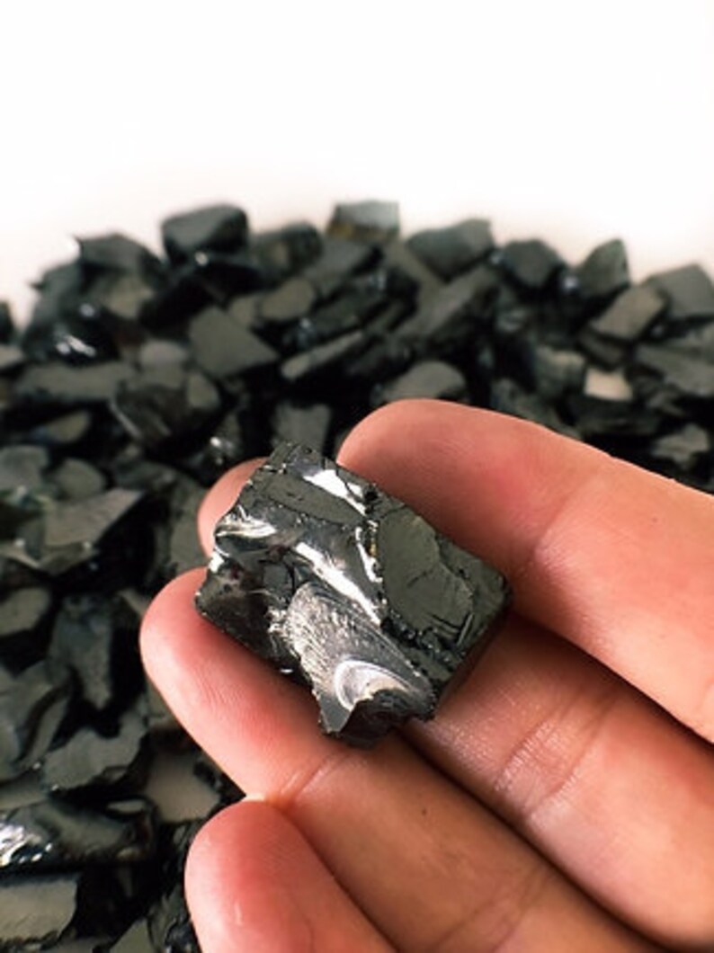 May include: A single, irregularly shaped piece of black hematite crystal. The crystal has a metallic sheen and is rough and jagged.