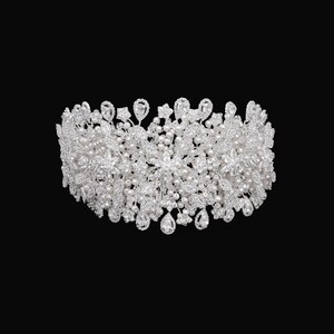 May include: A silver and white bridal headband with pearl and rhinestone embellishments