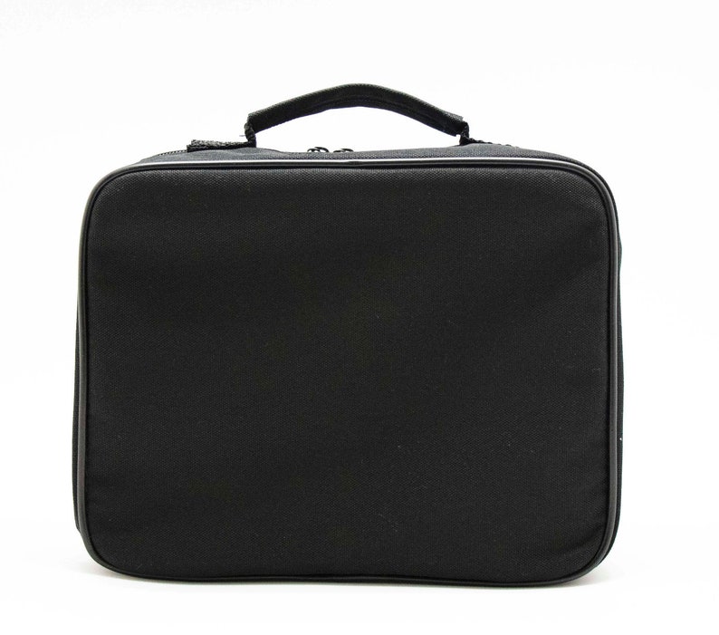 May include: A black zippered carrying case with a handle. The case is made of a soft, textured fabric.