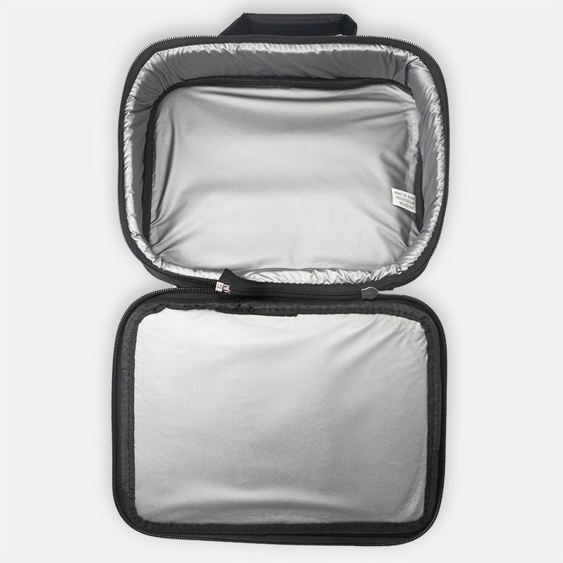 May include: Black insulated lunch bag with a zipper closure and a silver lining. The bag is open and empty.