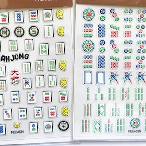 May include: Two sheets of Mahjong tile stickers. The first sheet features a variety of tiles with Chinese characters and numbers. The second sheet features a variety of tiles with circles, dots, and lines. Both sheets have the text "FEB-624" and "FEB-625" printed on them.