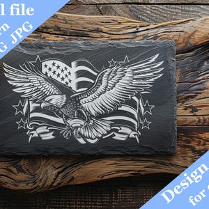 May include: A black and white digital design of an eagle with wings spread wide, holding an American flag in its talons. The design is on a slate background and includes the text "Design created for engraving on slate".