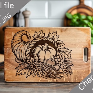 May include: Wooden charcuterie board with a laser-etched harvest design. The design features a cornucopia filled with a pumpkin, grapes, corn, and leaves. The words "Charcuterie design" are in the lower right corner.