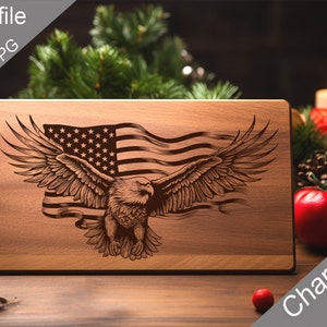 May include: A wooden cutting board with an engraved design of an American bald eagle flying with the American flag in the background. The board is on a wooden table with red berries and a candle in the background.