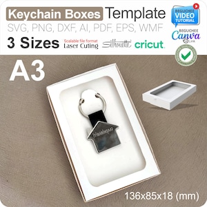 May include: A white rectangular box with a keychain inside. The keychain is silver-colored and shaped like a house, with the text "İTİBARİNŞAAT". The box measures 136x85x18 mm.