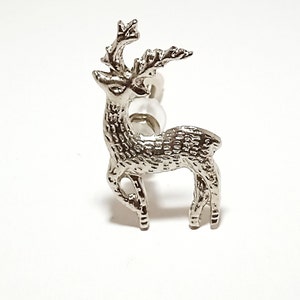 May include: Silver-toned deer figurine with antlers and a textured surface. The deer is standing on a white background.