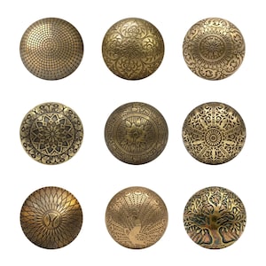 May include: Nine antique brass cabinet knobs with intricate embossed designs. The knobs feature various patterns, including floral, geometric, and a tree of life. Each knob is round and has a vintage, aged appearance, perfect for adding a touch of elegance.