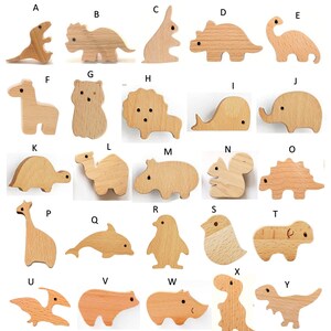 May include: A collection of twenty-five wooden animal figurines, each uniquely shaped and carved. The set includes a variety of animals, such as dinosaurs, elephants, and giraffes. The natural wood color highlights the intricate details of each figure.