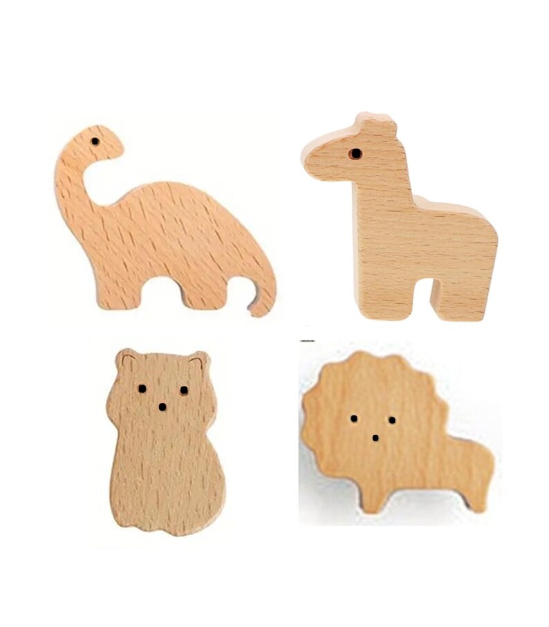 May include: Four wooden animal figures: a dinosaur, giraffe, bear, and lion. Each figure is cut from light-colored wood and features simple, rounded shapes. The dinosaur has a long neck, the giraffe stands upright, the bear is stout, and the lion has a mane.