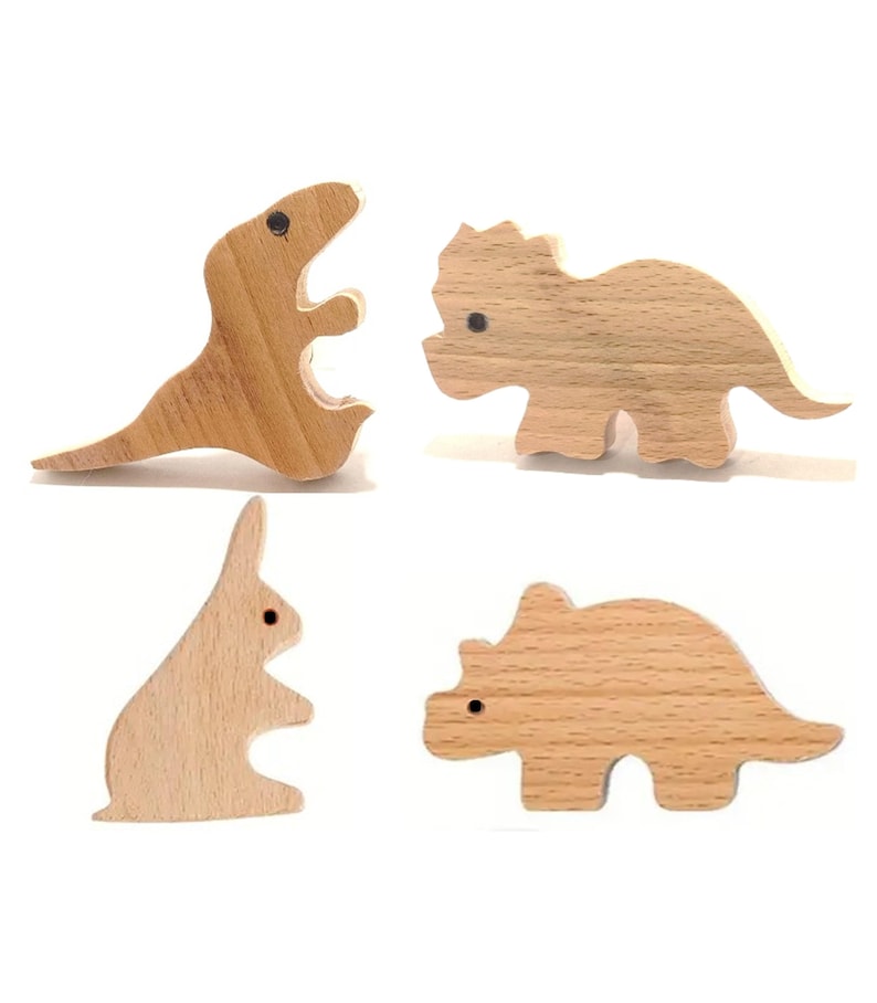May include: Four wooden toy figures: a Tyrannosaurus Rex, a Triceratops, a rabbit, and a Stegosaurus. Each figure is made of light-colored wood with a smooth finish and small black dot eyes. The toys are designed for children.
