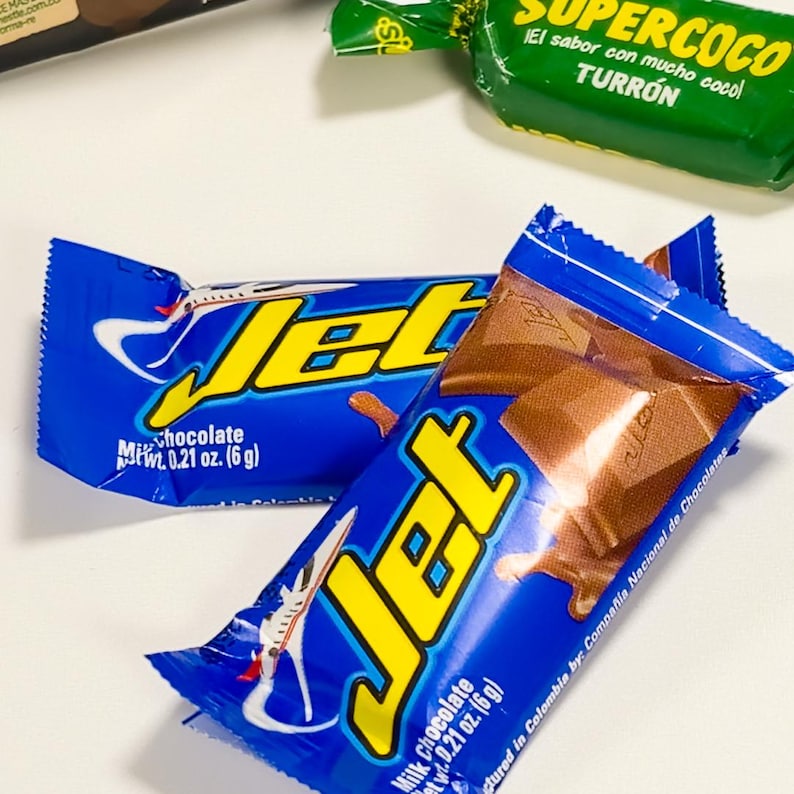 May include: Two blue and yellow Jet chocolate bars. The wrappers have the word "Jet" in large yellow letters. The bars are milk chocolate and weigh 0.21 oz (6 g). The wrappers also have a picture of an airplane.