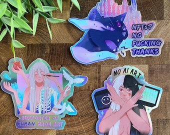 May include: Three holographic stickers with colorful designs and text. The first sticker features a black cat with a purple and blue background and the text "NFTS? NO FUCKING THANKS". The second sticker features a person with white hair and a skeleton body holding a paintbrush and doves with the text "SUPPORTER OF HUMAN MADE ART". The third sticker features a person with black and white hair with their arms crossed and the text "NO AI ART IN MY HOUSE".