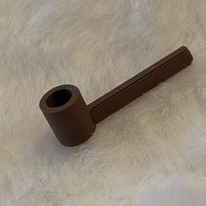May include: A brown ceramic pipe with a rounded bowl and a long, straight stem. The stem has a textured surface.