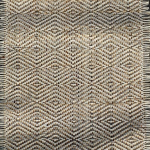 May include: Close-up of a woven mat with a diamond pattern. The mat is made of natural fibres and has a light brown colour.