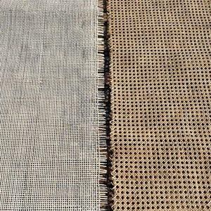 May include: Close-up of two different woven materials. On the left is a white, grid-like material. On the right is a tan, patterned material with small holes. The two materials are separated by a dark, fringed edge.