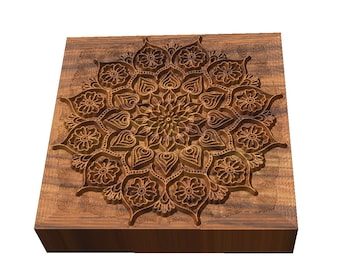May include: A wooden block with a carved mandala design. The mandala is intricate and detailed, with a variety of shapes and patterns. The wood is a rich brown color.