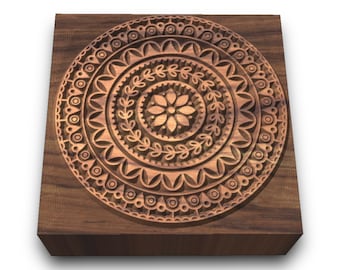 May include: A wooden block featuring a carved mandala design. The mandala is intricate and features a central flower with surrounding leaves and geometric patterns.