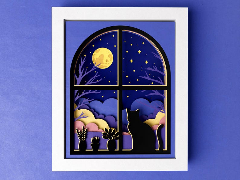 May include: Paper cut-out art depicting a window with a cat looking out at a night sky with a full moon and stars. The window is framed in black and has a purple, yellow, and pink layered background.