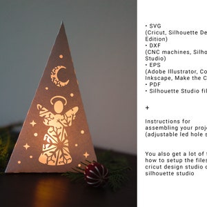 May include: A white paper Christmas tree with a cut-out angel design and a crescent moon. The tree is illuminated from behind, creating a warm glow. The image includes instructions for assembling the project, which includes an adjustable LED hole size. The text also mentions tips for setting up the files in Cricut Design Studio or Silhouette Studio.