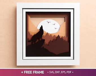 May include: A framed, layered paper art piece depicting a howling wolf silhouette on a rocky outcrop, set against a forest and a full moon. The artwork is in shades of brown and tan, with a white frame. Text at the bottom reads "+ FREE FRAME • SVG, DXF, EPS, PDF •".