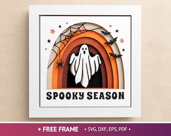May include: A white ghost with a spooky smile is framed in a rainbow arch with bats and a spider web. The text "Spooky Season" is below the arch.