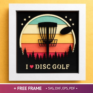 May include: A white frame with a black background and a silhouette of a disc golf basket in front of a sunset. The text "I ♥ DISC GOLF" is below the basket.