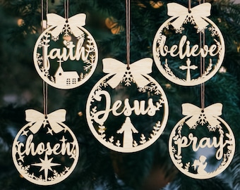 May include: Five wooden Christmas ornaments with a white background and a brown string. The ornaments have the words "faith", "believe", "Jesus", "chosen", and "pray" written on them.