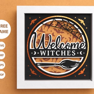 May include: A black and orange Halloween-themed welcome sign with the text "Welcome Witches" in a decorative font. The sign features a circle with a spiderweb, bats, and moons, and a broom at the bottom.