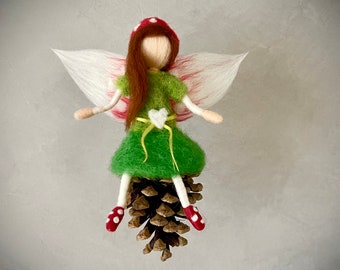 little toadstool fairy sitting on a pine cone elf angel felt fairy felted