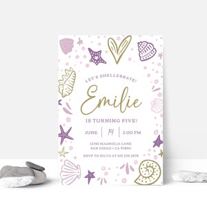 May include: A printable invitation for a child's birthday party with a seashell theme. The invitation is decorated with purple and gold seashells, starfish, and a heart. The text on the invitation reads "Let's Shell-ebrate! Emilie is turning five! June 14, 2:00 PM, 12345 Magnolia Lane, San Diego, CA 97890, RSVP to Silva at 619.234.5678".