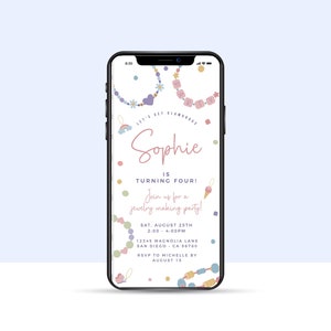 May include: A smartphone screen displaying a colorful invitation for a jewelry making party for Sophie's 4th birthday. The invitation features a rainbow, a butterfly, ice cream cones, and colorful beads. The text reads "Let's get glamorous, Sophie is turning four! Join us for a jewelry making party! Sat, August 25th, 2:00-4:00pm, 12345 Magnolia Lane, San Diego, CA 96780, RSVP to Michelle by August 15."